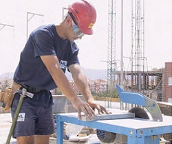 Trabajador de la construcción cortando con una sierra circular